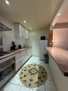 a kitchen with a refrigerator and a table in it at La ruche in Bourg-de-Péage