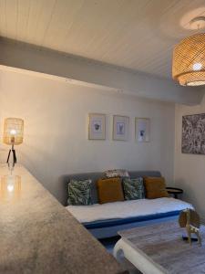 a living room with a couch and a table at La ruche in Bourg-de-Péage