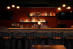 a bar with chairs and bottles of alcohol at Hotel la Fontaine du Mont Blanc in Les Houches +73 photos