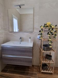 a bathroom with a sink and a mirror at ASTRA Guest House in Taranto