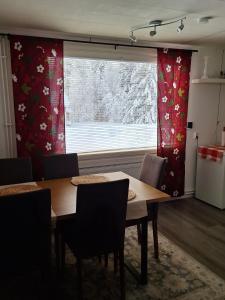 a dining room with a table and a window at MarrasVilla in Marrasjärvi