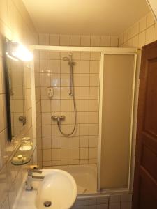 a bathroom with a shower and a sink at Hotel Büker in Erwitte