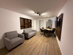 a living room with a table and chairs at Shiro Lodge in Predeal