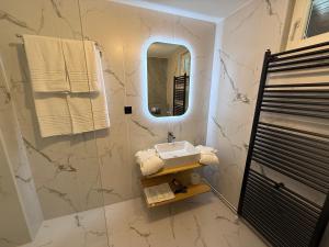 a bathroom with a sink and a mirror at Shiro Lodge in Predeal +8 photos
