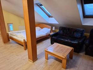 a living room with a couch and a bed at Simon-Dach-Haus in Klaipėda