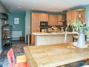 a kitchen with wooden cabinets and a wooden table at Brooklands in Uplyme