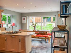 a kitchen with a table and a bench in it at Brooklands in Uplyme