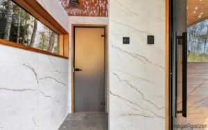 a door to a house with marble walls at Luxury Resort Päikeseoru in Pedajamäe