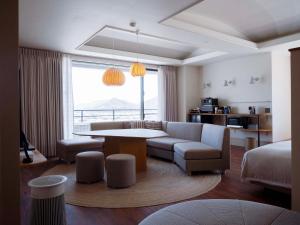 a living room with a couch and a table at Hotel Espacio 山口 -ADULT ONLY- in Yamaguchi