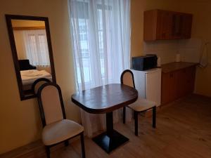 a small kitchen with a table and chairs in a room at Simon-Dach-Haus in Klaipėda +24 photos