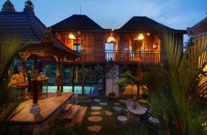 a house with a deck and a swimming pool at Tri Datu Palace in Saba