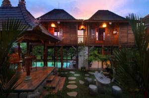 a house with a deck and a swimming pool at Tri Datu Palace in Saba +39 photos