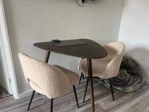a table and two chairs in a room at The Little Red lion in Thorpe
