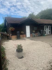 a log cabin with a porch and a white door at The Little Red lion in Thorpe