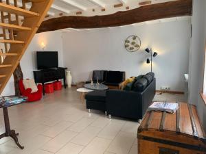 a living room with a couch and a table at La ciboulette in Les Loges