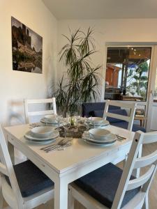 a white dining room table with plates and silverware at Dokazien in Waldems
