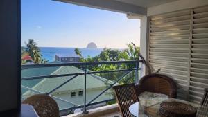 a balcony with a view of the ocean at Le chant du Diamant calme vue mer et plage à 50 m in Le Diamant