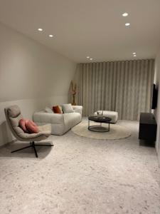 a living room with two couches and a table at The Corner -FRANS in Beernem