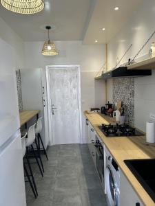 a kitchen with a sink and a stove top oven at Jasmine Apartment Tunis in Tunis