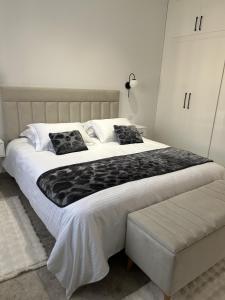 a large white bed with two pillows on it at Jasmine Apartment Tunis in Tunis