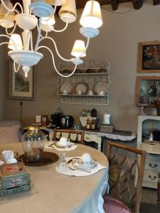 a dining room with a table with a chandelier at Aria di Campagna in Lodi