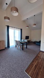 a living room with a table and a couch at Skalnica- apartamenty z widokiem na góry, przy szlakach in Karpacz