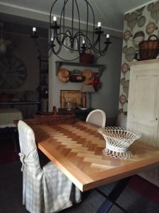 a dining room with a wooden table and a chandelier at Aria di Campagna in Lodi +7 photos