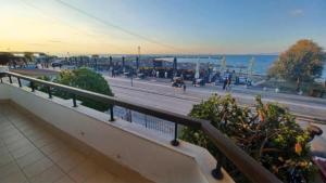 a balcony with a view of a street and the ocean at Villa Veranda in Neoi Epivates