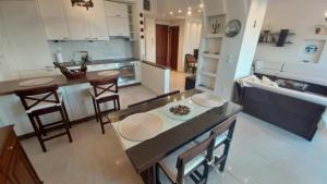 a kitchen with a table and some chairs in it at Villa Veranda in Neoi Epivates +8 photos