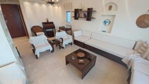 a living room with a white couch and a table at Villa Veranda in Neoi Epivates