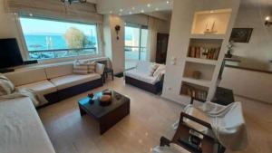 a living room with a couch and a table at Villa Veranda in Neoi Epivates