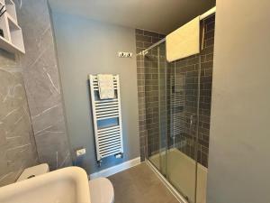 a bathroom with a glass shower and a toilet at Chislehurst House in Bedford +14 photos