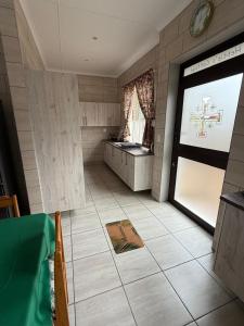 a room with a large door in a room at Hettie's Cottage in Hartenbos