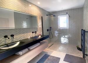 a bathroom with a sink and a large mirror at Luxury Villa, Infinity Pool, Beach 5 min in Ramatuelle +13 photos