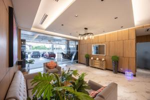 a living room with a couch and chairs and a tv at Layla by J&J At J Towers Residences It's just right next to SM JMall in Mandaue City