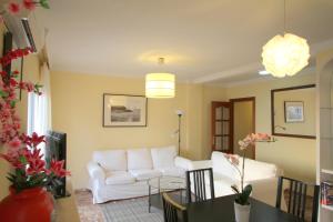 a living room with a white couch and a table at Malaga Soho in Málaga