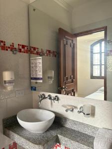 a bathroom with a sink and a large mirror at Hotel Chucarima in Cúcuta +20 photos