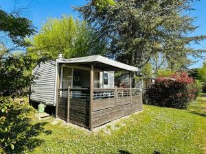 a small cabin with a porch in a yard at Camping 3 étoiles - Piscine - ccbfgbf in Collias
