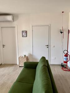 a living room with a green couch in a room at La Casa Di Elda in Terni