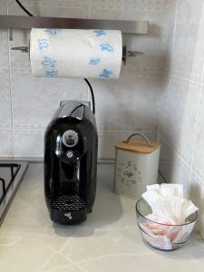 a coffee maker on a counter with a roll of paper towels at La Casa Di Elda in Terni
