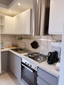 a kitchen with a stove and a sink at La Casa Di Elda in Terni