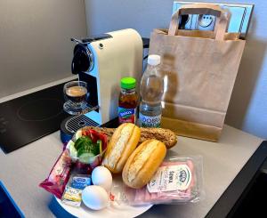 a table with a plate of food and a paper bag at Hotel Awam in Hradec Králové