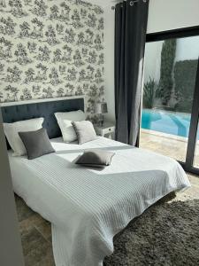 a bedroom with a large bed with a large window at Superbe villa golfe st Tropez in Sainte-Maxime +39 photos