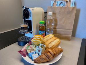a plate of food on a table with bread and drink at Hotel Awam in Hradec Králové +7 photos