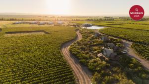 an aerial view of a farm with tractors in a field at Chozos Resort in Agrelo