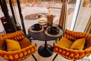 a table and chairs in a room with a table and a table at Luxury Resort Ehametsa in Vaibla