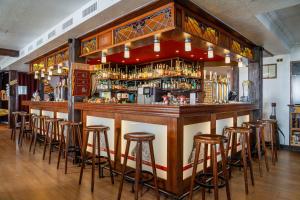 a bar with bar stools in a room at Gasthof zum Falken in Frauenfeld