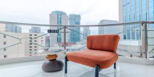 a chair and a table in a room with a window at 上海NICE民宿 Shanghai NICE B&B ZFC in Shanghai