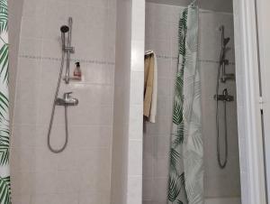 a shower with a glass door and a shower at Le relais Poyo in Arquian