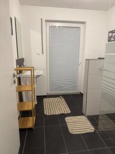 a bathroom with a sink and a toilet and a window at Lingen Stay in Lingen
